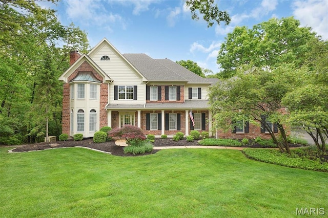 1508 Pacland Ridge Ct, Chesterfield, MO 63005 - view of front of house with a chimney, a front lawn, and brick siding