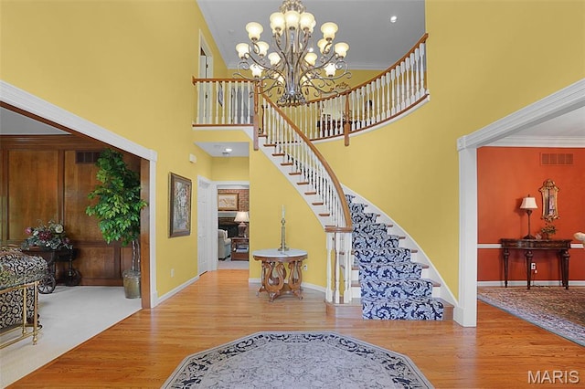 1508 Pacland Ridge Ct, Chesterfield, MO 63005 - foyer entrance with stairway, wood finished floors, a high ceiling, a chandelier, and baseboards