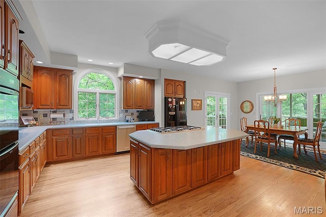1508 Pacland Ridge Ct, Chesterfield, MO 63005 - kitchen with stainless steel appliances, light wood finished floors, a chandelier, healthy amount of natural light, and recessed lighting