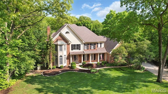 1508 Pacland Ridge Ct, Chesterfield, MO 63005 - traditional-style home featuring a chimney, a front yard, concrete driveway, and brick siding