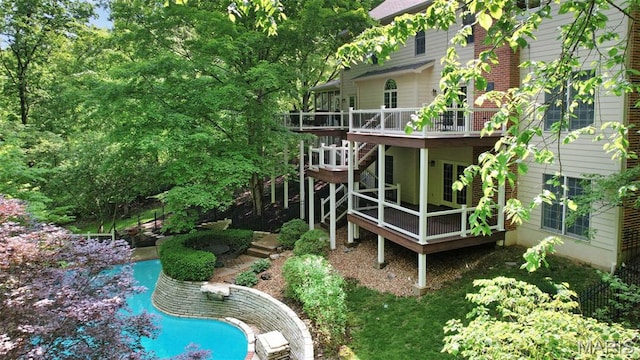 1508 Pacland Ridge Ct, Chesterfield, MO 63005 - back of property with a deck, an outdoor pool, and stairway
