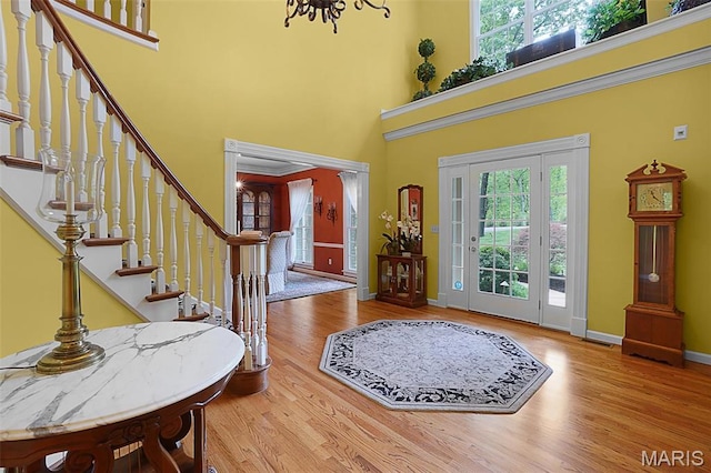 1508 Pacland Ridge Ct, Chesterfield, MO 63005 - foyer with a towering ceiling, a chandelier, stairs, and wood finished floors
