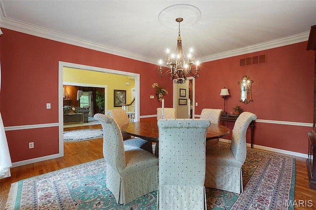 1508 Pacland Ridge Ct, Chesterfield, MO 63005 - dining space featuring a chandelier, ornamental molding, and wood finished floors