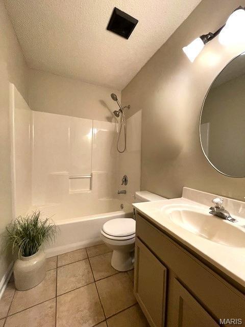 bathroom featuring a textured ceiling, toilet, tile patterned floors, vanity, and shower / bathtub combination