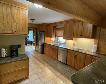 577 Schluersburg Rd, Augusta, MO 63332 - kitchen with stainless steel appliances, a sink, light tile patterned floors, dark countertops, and brown cabinetry