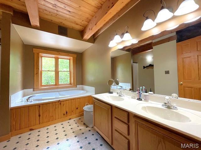 577 Schluersburg Rd, Augusta, MO 63332 - full bath featuring tile patterned floors, double vanity, wood ceiling with exposed beams, and a garden tub