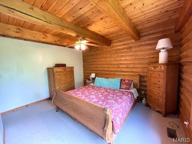 577 Schluersburg Rd, Augusta, MO 63332 - carpeted bedroom featuring wood ceiling with exposed beams, rustic walls, baseboards, and ceiling fan