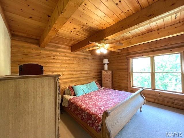 577 Schluersburg Rd, Augusta, MO 63332 - carpeted bedroom with wood ceiling with exposed beams, log walls, and ceiling fan