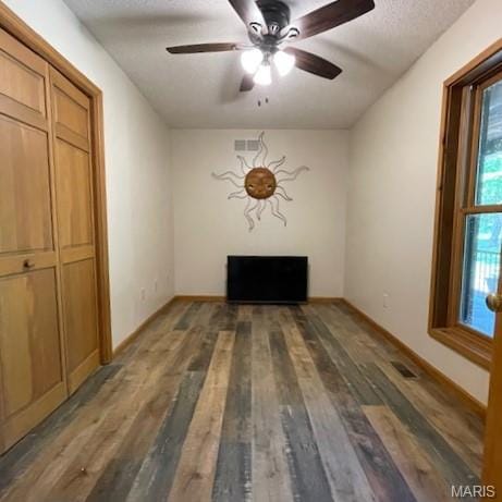 577 Schluersburg Rd, Augusta, MO 63332 - unfurnished dining area with wood finished floors, ceiling fan, baseboards, and a textured ceiling