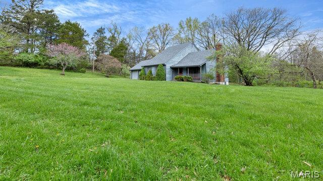 28470 Sunnyside Rd, Warrenton, MO 63383 - view of grassy yard featuring a garage