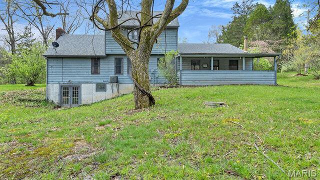 28470 Sunnyside Rd, Warrenton, MO 63383 - rear view of property with french doors, a lawn, a sunroom, and a chimney