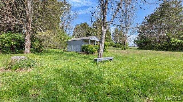 28470 Sunnyside Rd, Warrenton, MO 63383 - view of green lawn with an outbuilding