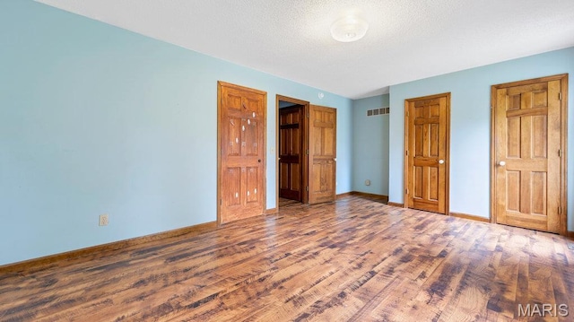 28470 Sunnyside Rd, Warrenton, MO 63383 - unfurnished bedroom with wood finished floors and baseboards