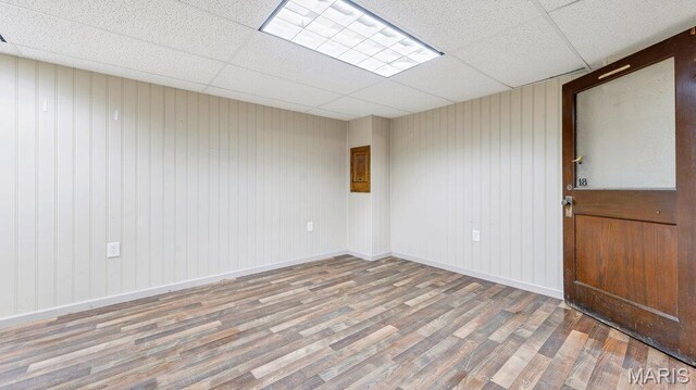28470 Sunnyside Rd, Warrenton, MO 63383 - empty room with wood finished floors, a drop ceiling, and baseboards