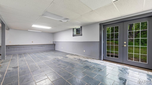 28470 Sunnyside Rd, Warrenton, MO 63383 - unfurnished room featuring french doors, a drop ceiling, plenty of natural light, and wainscoting
