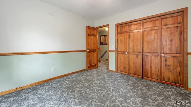 28470 Sunnyside Rd, Warrenton, MO 63383 - unfurnished bedroom featuring carpet, baseboards, a closet, and a textured ceiling