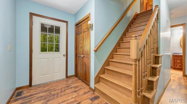 28470 Sunnyside Rd, Warrenton, MO 63383 - foyer with wood finished floors, stairs, and baseboards