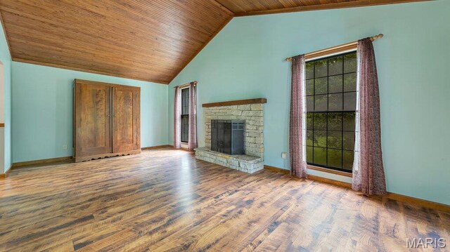 28470 Sunnyside Rd, Warrenton, MO 63383 - unfurnished living room with wood ceiling, wood finished floors, a stone fireplace, baseboards, and high vaulted ceiling