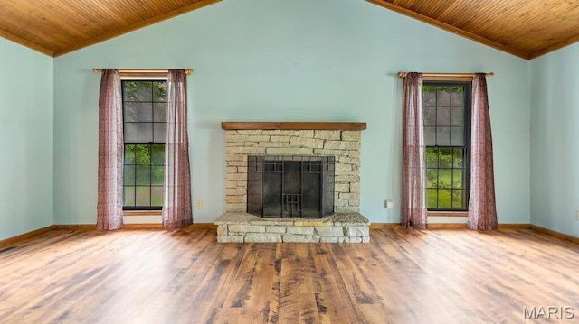28470 Sunnyside Rd, Warrenton, MO 63383 - unfurnished living room featuring wooden ceiling, wood finished floors, plenty of natural light, a fireplace with raised hearth, and baseboards