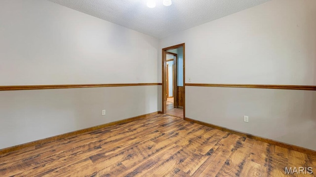 28470 Sunnyside Rd, Warrenton, MO 63383 - spare room featuring wood finished floors, a textured ceiling, and baseboards