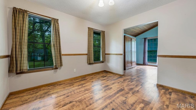 28470 Sunnyside Rd, Warrenton, MO 63383 - empty room featuring wood finished floors, lofted ceiling, and baseboards