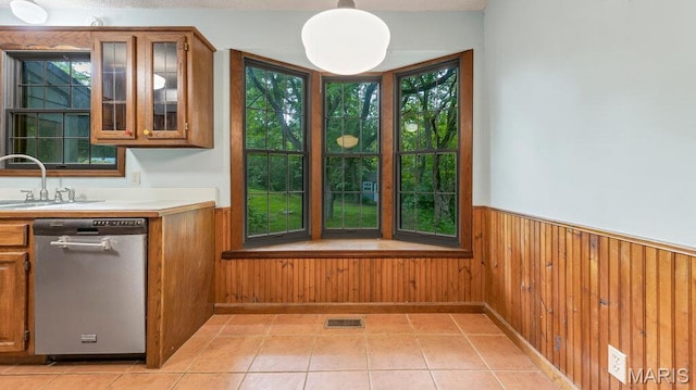 28470 Sunnyside Rd, Warrenton, MO 63383 - unfurnished dining area with wainscoting, a sink, wood walls, and light tile patterned floors