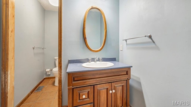 28470 Sunnyside Rd, Warrenton, MO 63383 - half bath featuring vanity, toilet, tile patterned floors, and baseboards