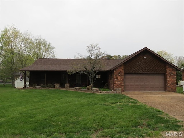 view of front of property featuring an attached garage, concrete driveway, a front yard, and brick siding