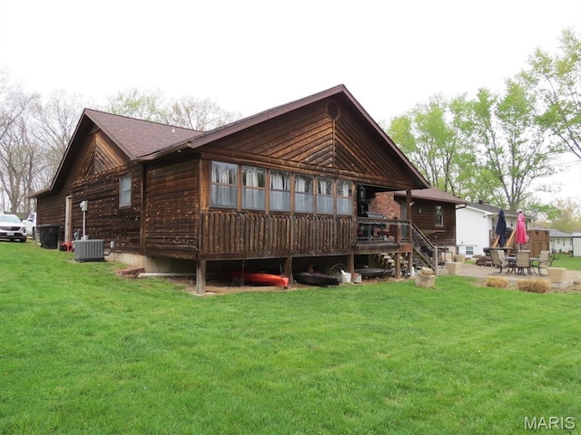 back of property with a yard, a patio, a wooden deck, and central AC unit