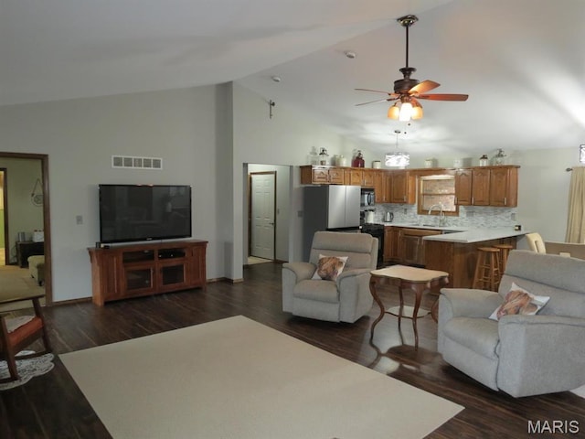 living room featuring a ceiling fan, dark wood-style flooring, high vaulted ceiling, and baseboards