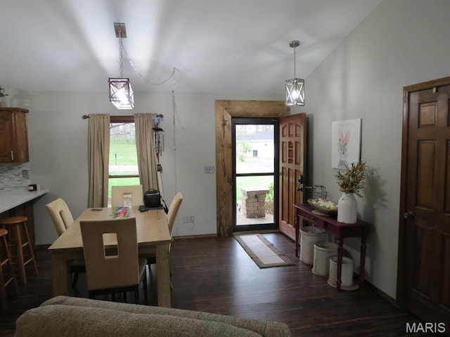 foyer featuring dark wood-style flooring, vaulted ceiling, and baseboards