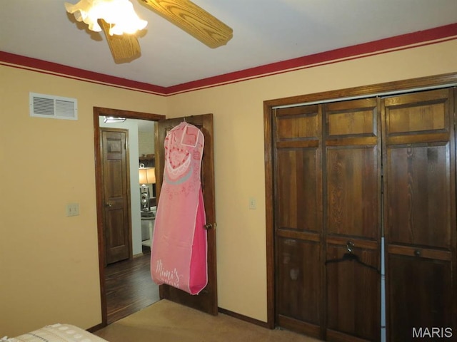 bedroom with carpet flooring, a ceiling fan, baseboards, and a closet