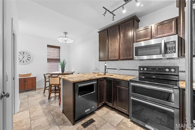 4366 W Pine Blvd Unit Cw, Saint Louis, MO 63108 - kitchen featuring appliances with stainless steel finishes, dark brown cabinetry, tasteful backsplash, a sink, and light stone countertops