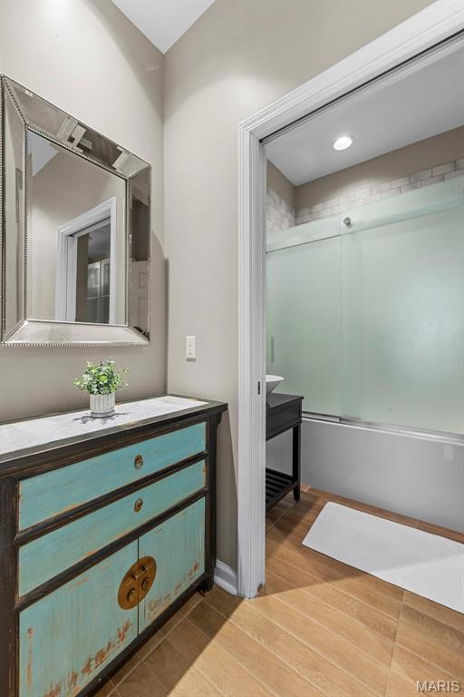 4366 W Pine Blvd Unit Cw, Saint Louis, MO 63108 - full bath with vanity, shower / bath combination with glass door, and wood finished floors