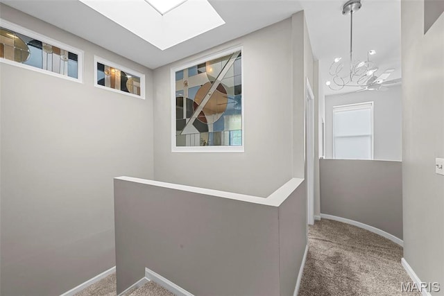 4366 W Pine Blvd Unit Cw, Saint Louis, MO 63108 - corridor featuring an upstairs landing, carpet floors, a skylight, baseboards, and a chandelier