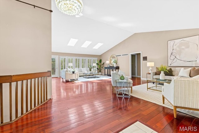 living room featuring wood finished floors, a chandelier, and high vaulted ceiling