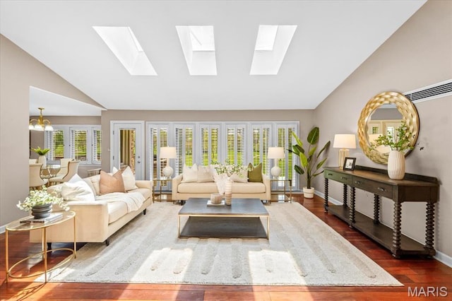 living area with a skylight, wood finished floors, high vaulted ceiling, and baseboards