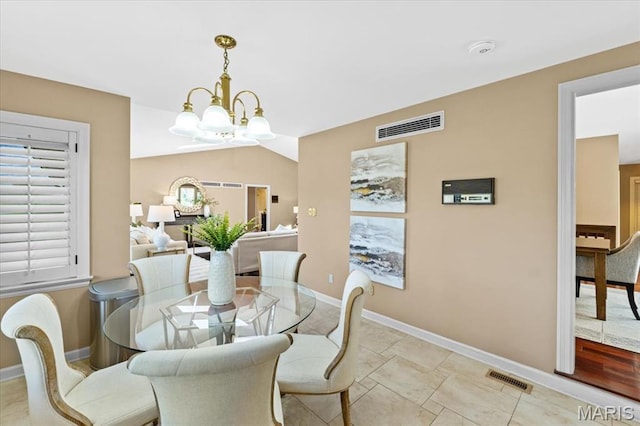 dining area with a chandelier and baseboards