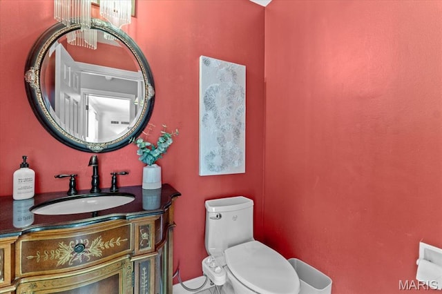 half bath with toilet, vanity, and tile patterned flooring