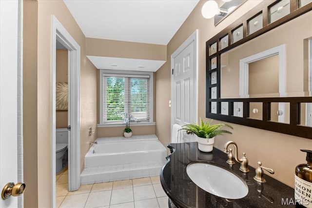 full bathroom featuring a sink, toilet, tile patterned flooring, and a garden tub