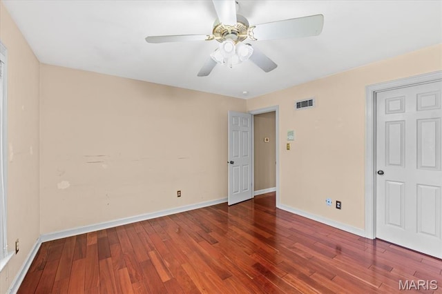 empty room with wood finished floors, baseboards, and ceiling fan