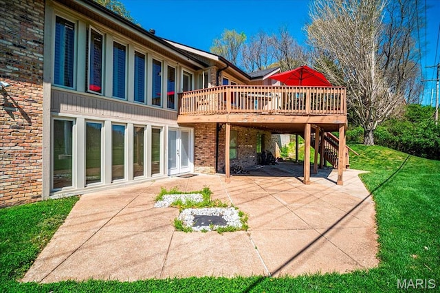 back of house featuring a patio area, a wooden deck, brick siding, stairway, and a lawn