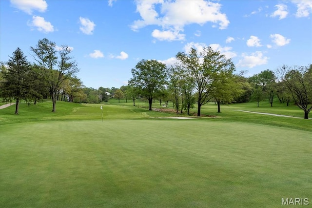 2244 Kehrsglen Ct, Clarkson Valley, MO 63005 - view of community with golf course view, view of wooded area, a yard, and a putting green