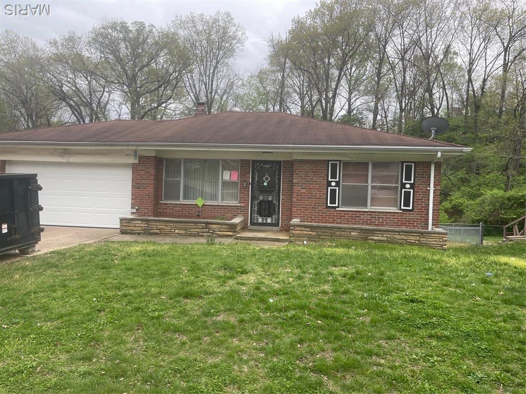 6934 Winchester Dr, Saint Louis, MO 63121 - single story home with brick siding, a garage, a front yard, and concrete driveway