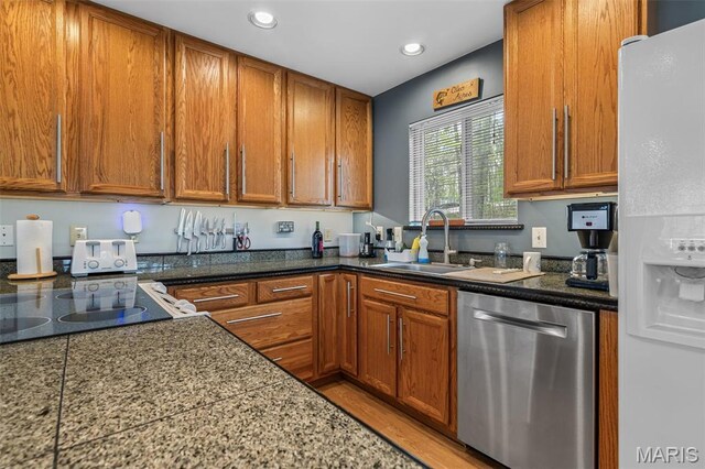 13219 Apache Point Dr, Saint Genevieve, MO 63670 - kitchen with stainless steel dishwasher, white refrigerator with ice dispenser, a sink, brown cabinetry, and recessed lighting