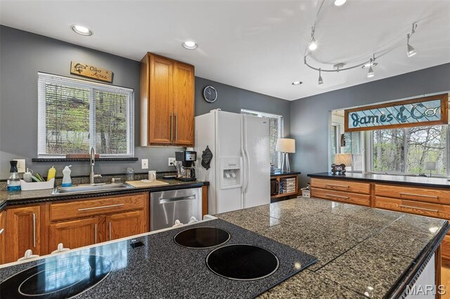 13219 Apache Point Dr, Saint Genevieve, MO 63670 - kitchen featuring tile counters, white refrigerator with ice dispenser, a sink, stainless steel dishwasher, and brown cabinets