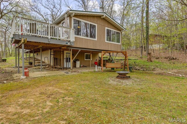 13219 Apache Point Dr, Saint Genevieve, MO 63670 - rear view of house with a deck, an outdoor fire pit, a yard, and a patio area