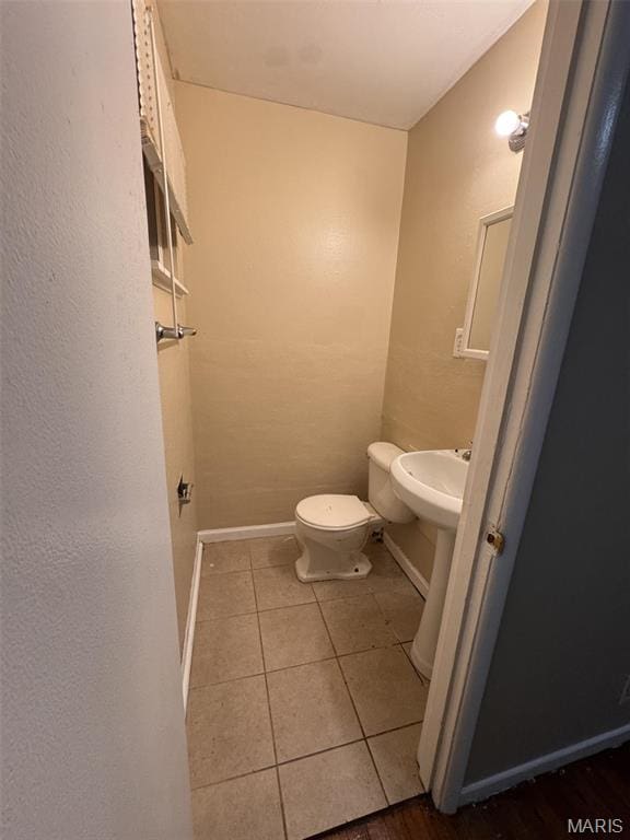 10115 Saffron Dr, Saint Louis, MO 63136 - bathroom with tile patterned floors, toilet, and baseboards