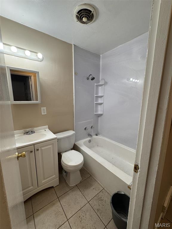 10115 Saffron Dr, Saint Louis, MO 63136 - full bathroom featuring tile patterned floors, vanity, tub / shower combination, and toilet