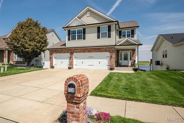 1338 Orchard Lakes Cir, Belleville, IL 62220 - view of front of property with brick siding, driveway, a front yard, and a garage
